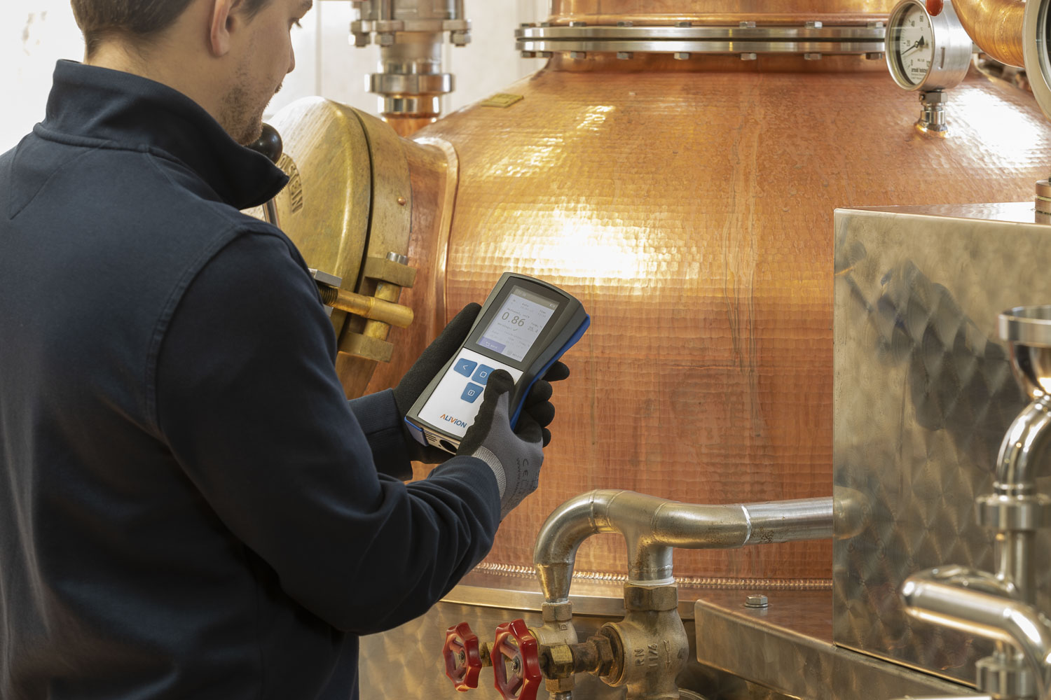 Alivion Spark handheld device used at a copper still